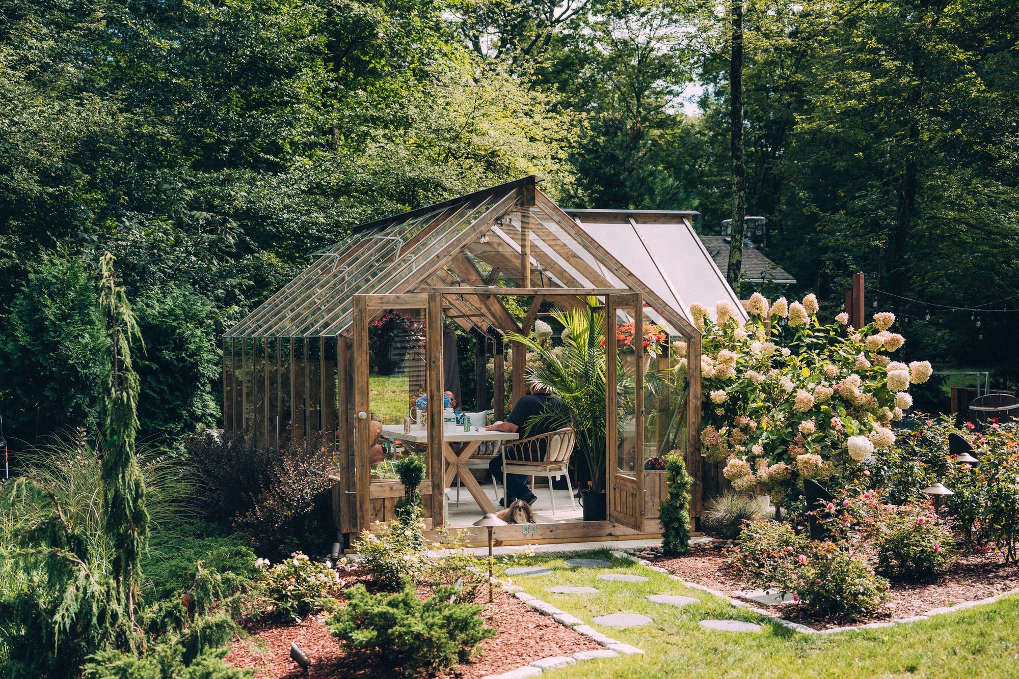 Nordwood timber and glass greenhouse with hydrangeas