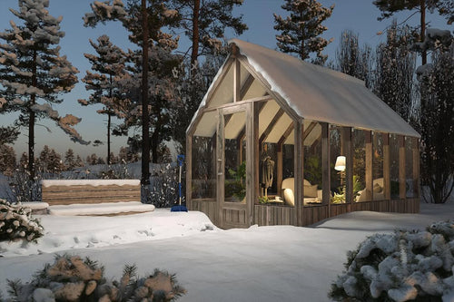 Wooden cabin with glass walls in a snowy forest