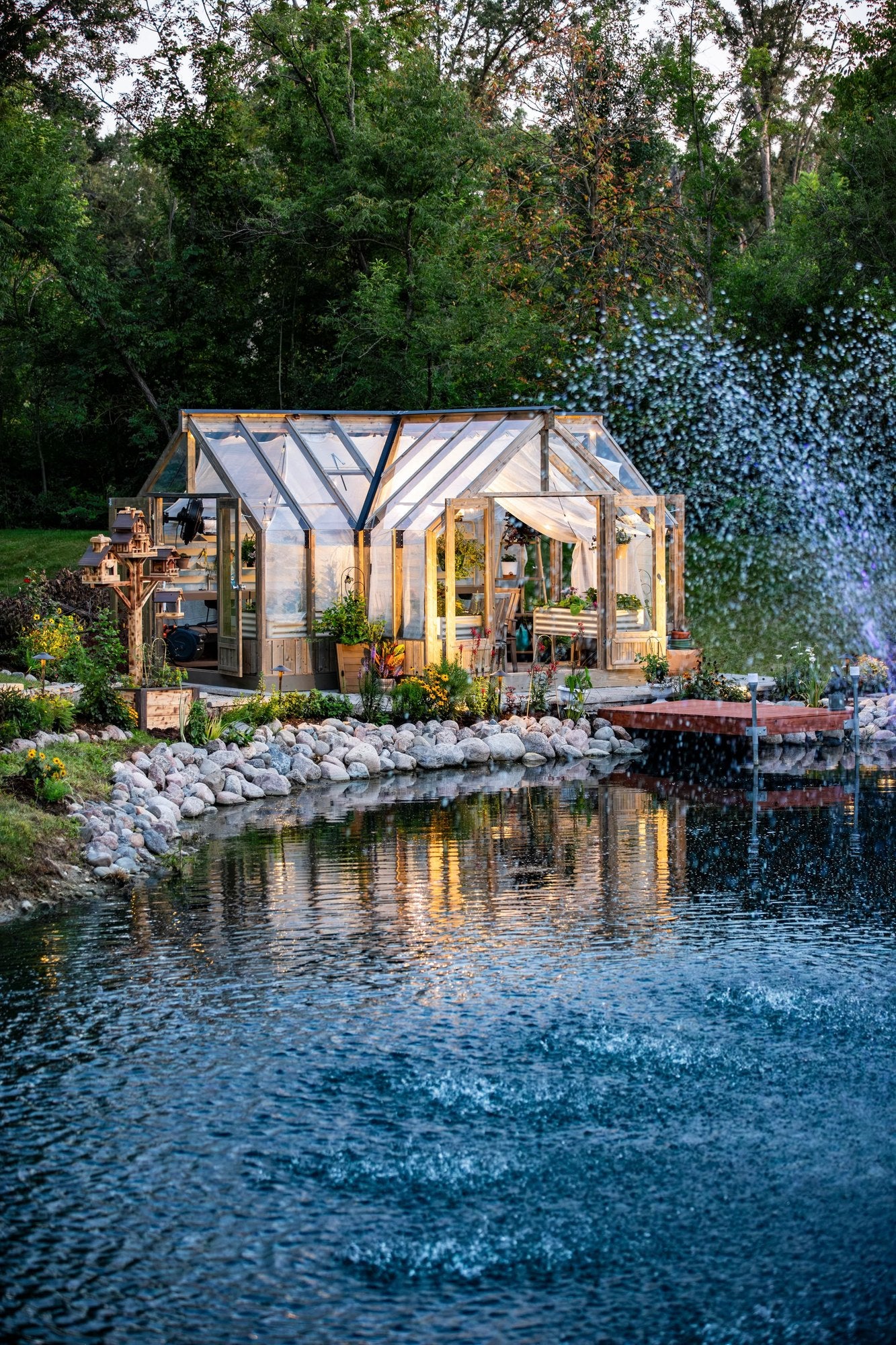 Nordwood greenhouse and fountain at dusk