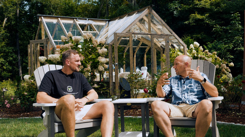 Gustavs and Dan in garden chairs in front of Dan's Nordwood