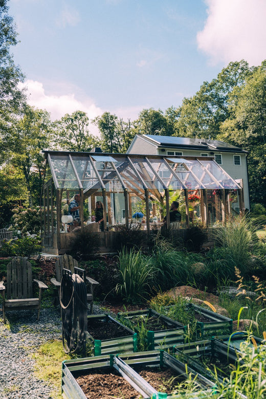 Raised beds beside a Nordwood greenhouse