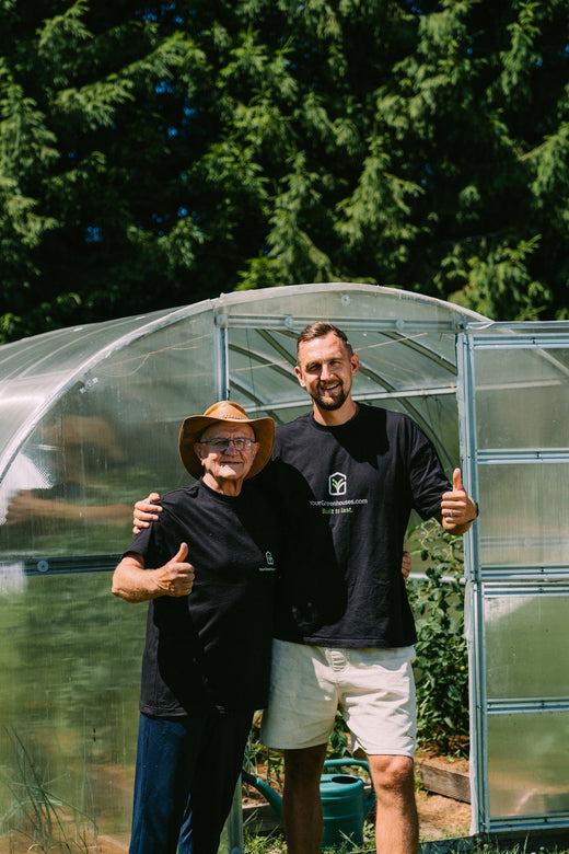 Gustavs, founder of YourGreenhouses, with his father at a polycarbonate greenhouse